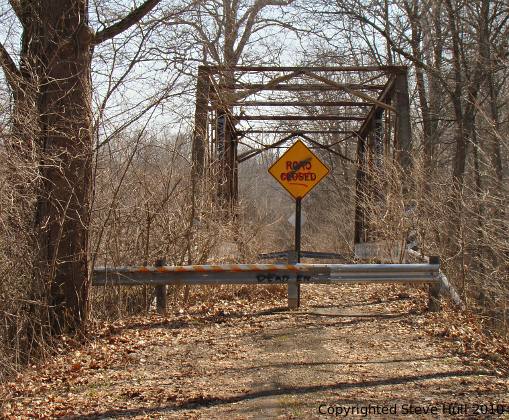 A rusty abandoned iron bridge.